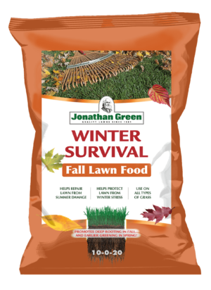 Bag of Winter Survival Fall Lawn Fertilizer, with product benefits listed on the orange front label amidst autumn leaves.
