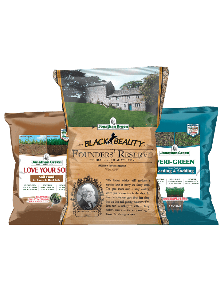 The Founders Reserve Lawn Care Bundle includes three key Jonathan Green products: a brown bag of soil food, a gold bag of grass seed mixture displaying a house illustration, and a blue bag of seeding and sodding fertilizer.