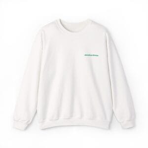 The JG Embroidered Heavy Blend™ Crewneck Sweatshirt is a plain white crewneck with small green "Jonathan Green" text embroidered on the left chest.