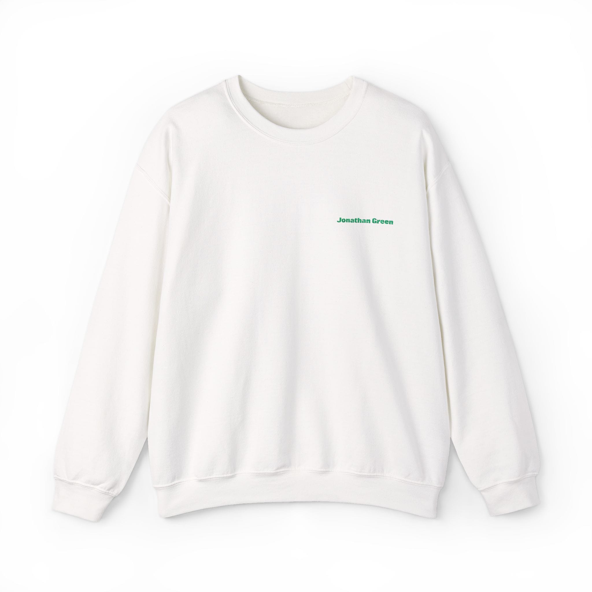 The JG Embroidered Heavy Blend™ Crewneck Sweatshirt is a plain white crewneck with small green "Jonathan Green" text embroidered on the left chest.