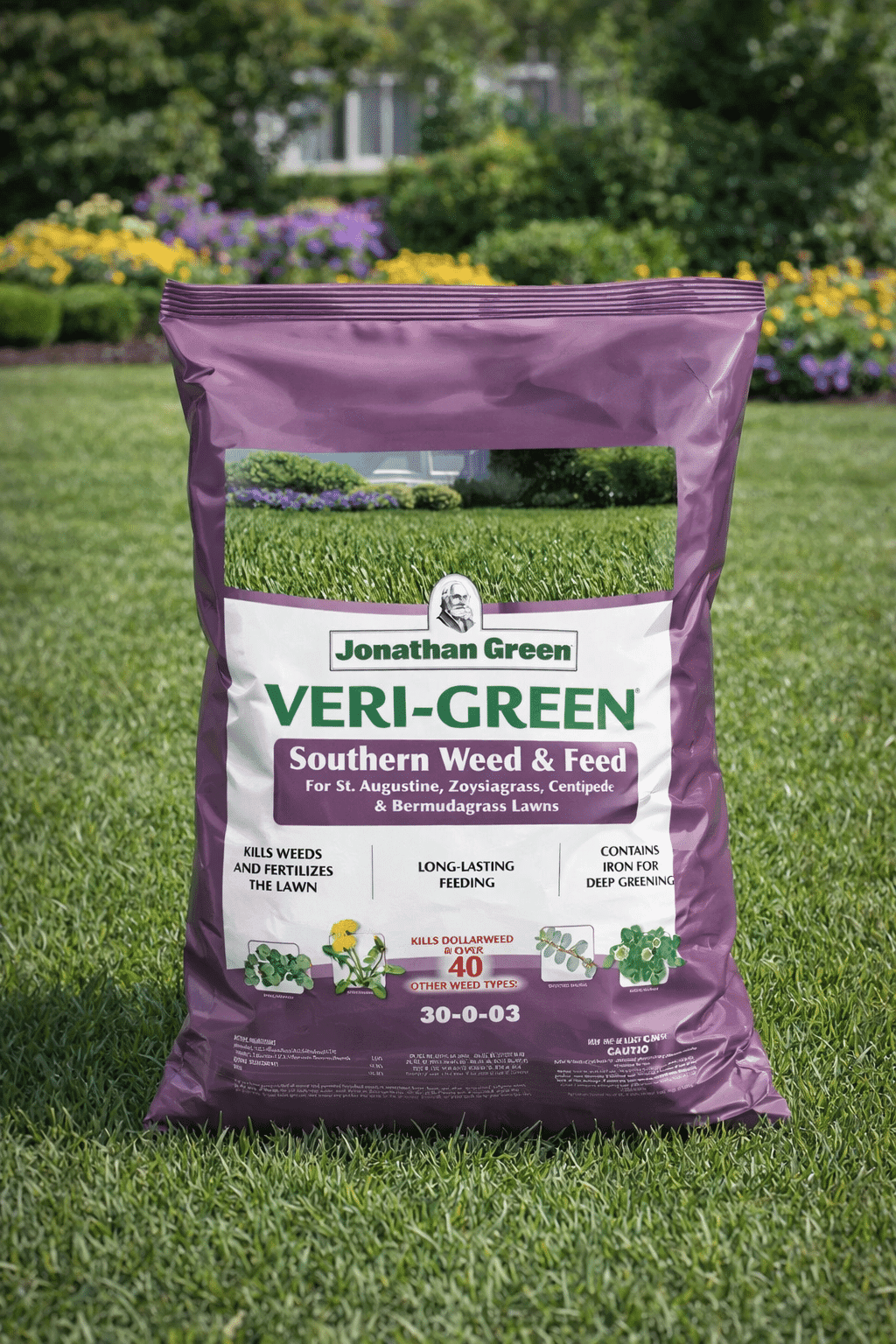 A bag of Veri-Green Southern Weed & Feed rests on lush green grass in a garden setting.