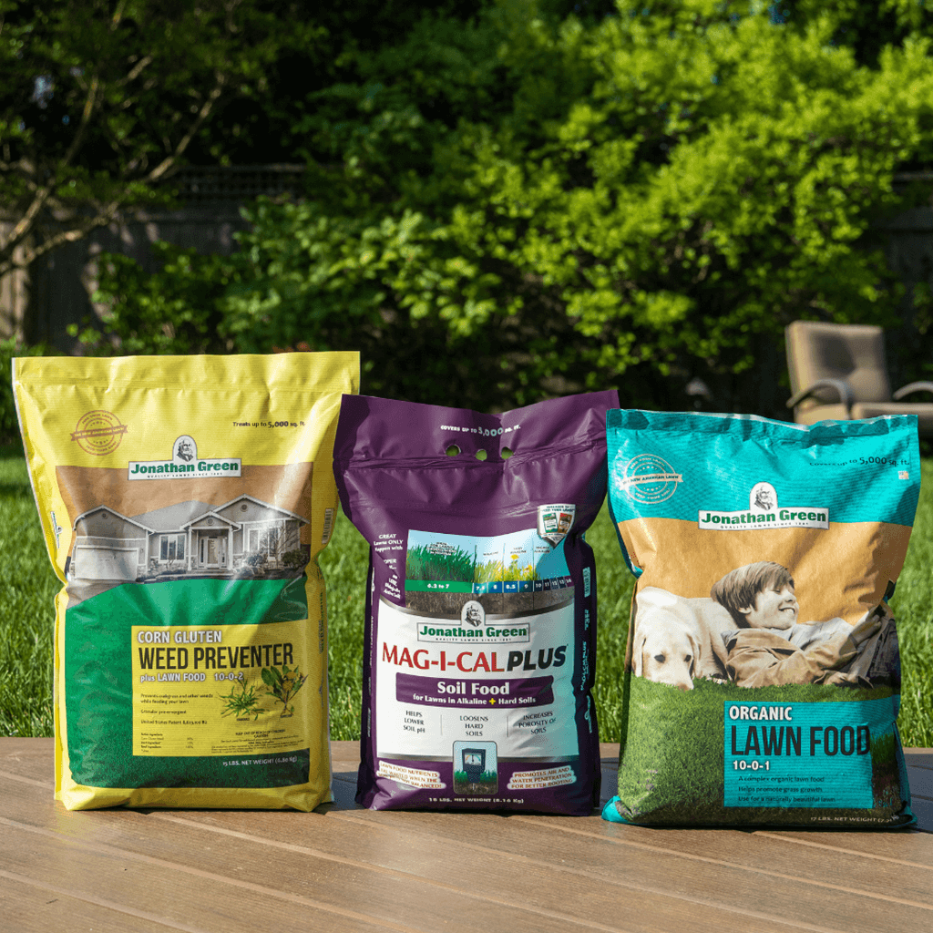 Three bags of GreenView Natural Annual Lawn Care Program for Alkaline Soil displayed on grass.